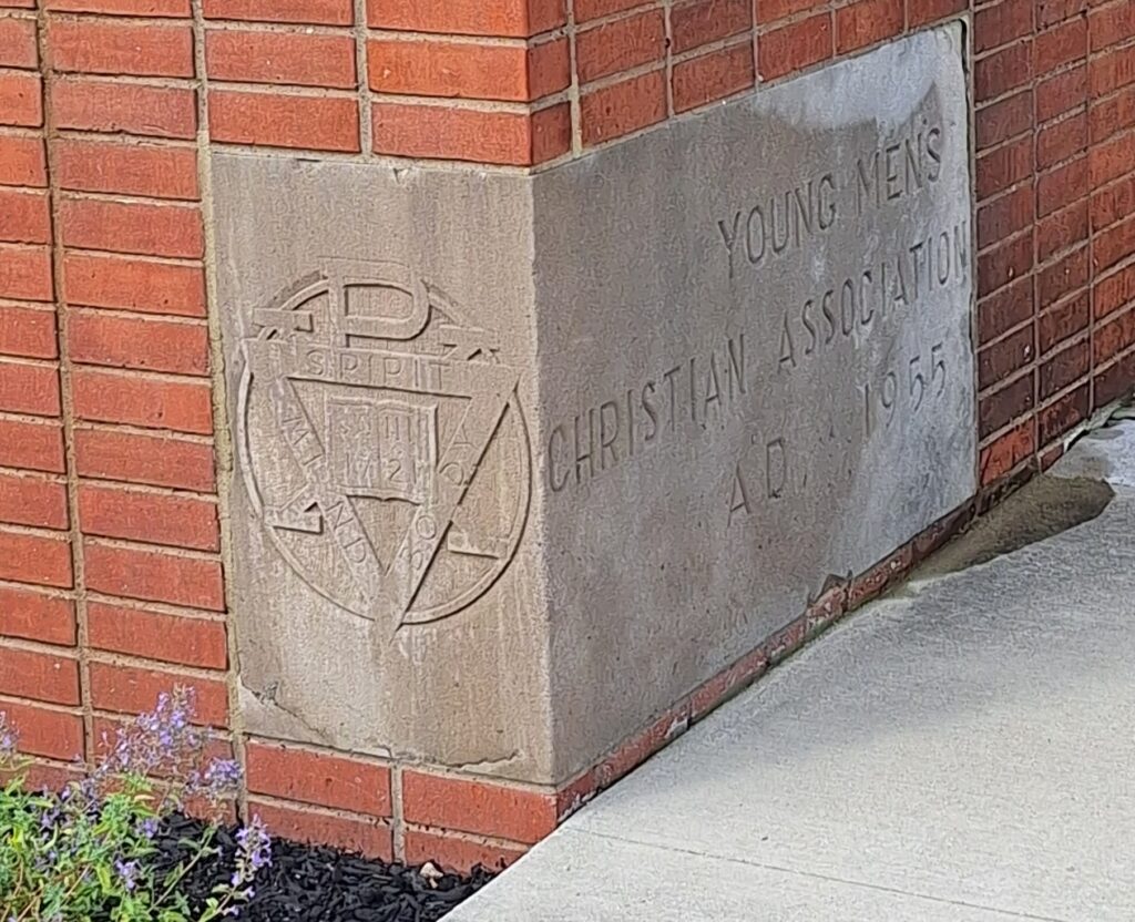 Visitors to APEC see the original YMCA cornerstone at the front entrance.